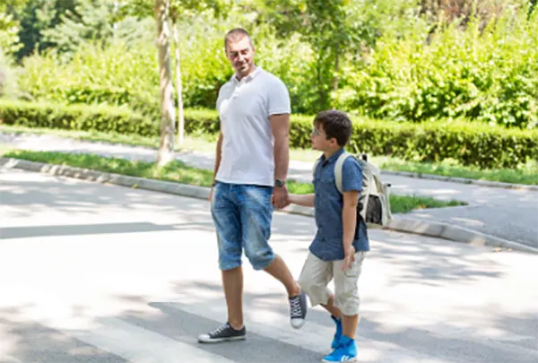 Parent and child having a calm conversation while walking outside